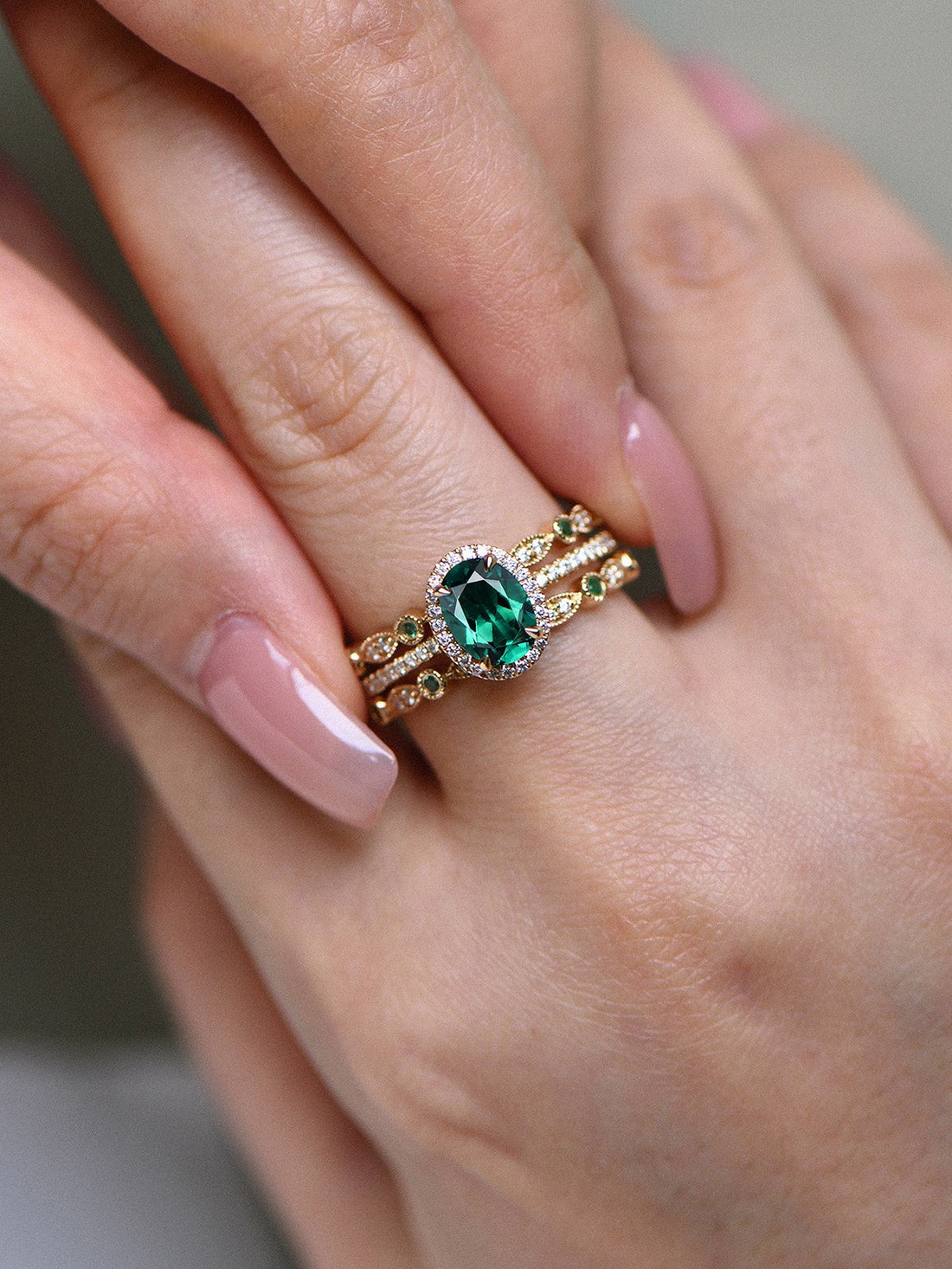 Solid gold emerald engagement ring close-up showing prong setting