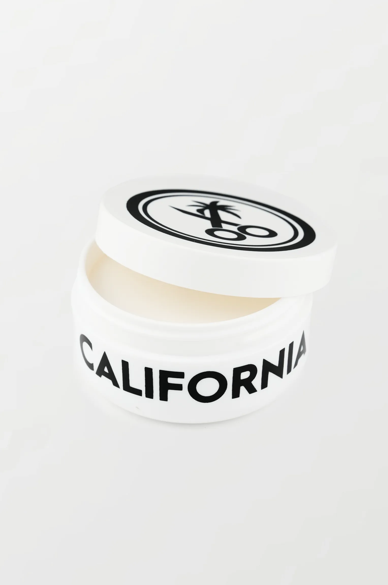 California Born Styling Paste product in container showing the paste texture and hold