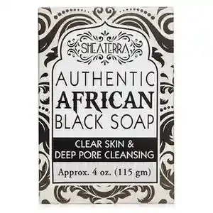 African black soap bar from Shea Terra Organics next to raw plantain and shea butter ingredients