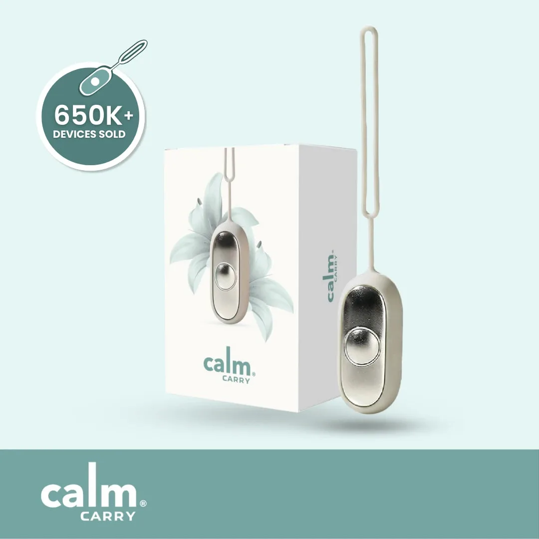 CalmCarry review grey microcurrent device showing the metal palm contact surface