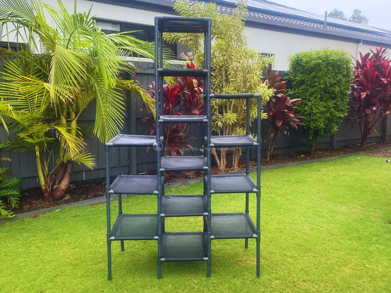 LuxeyPets SkyRise cat tower with 13 tiers assembled outdoors, showing the PVC frame and Textilene mesh platforms
