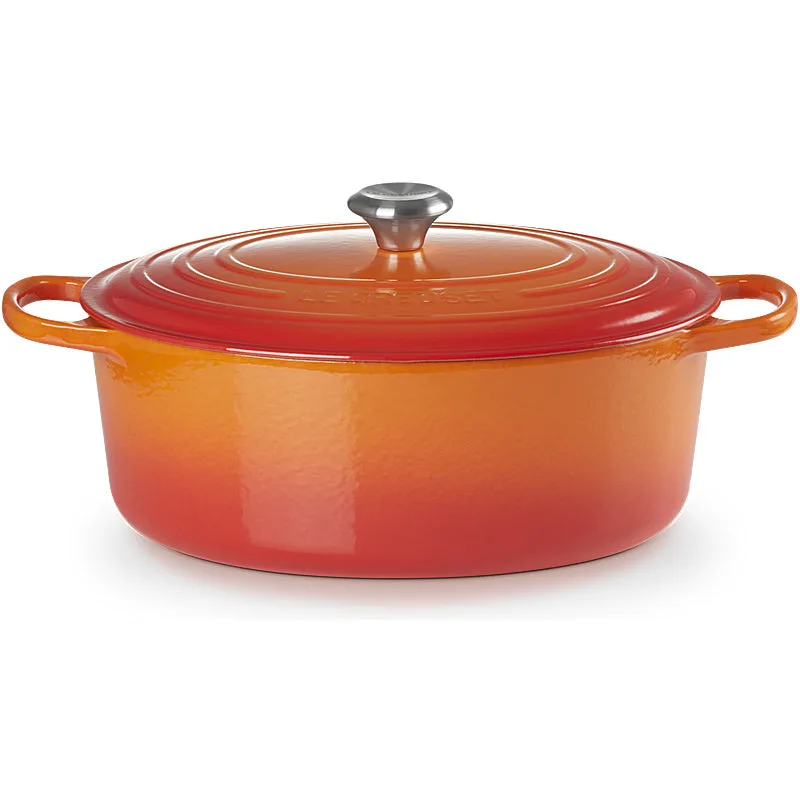 Le Creuset Dutch oven in Oven Red enamel showing the glossy coating and cast-iron handles