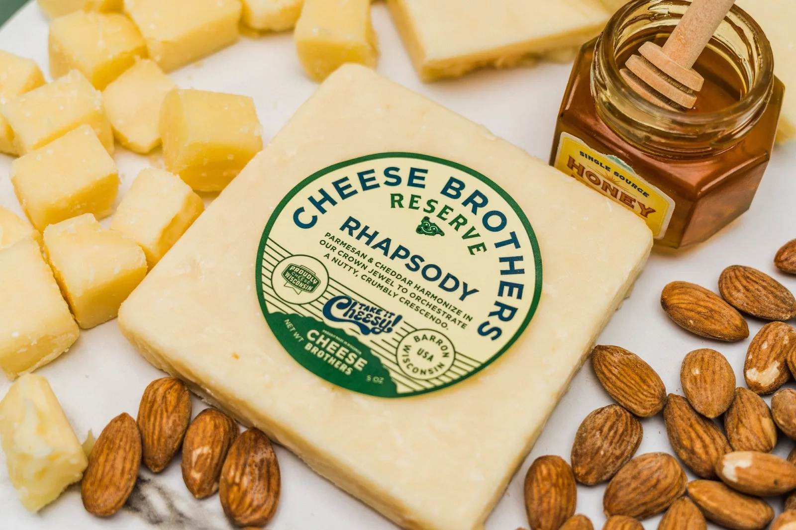 Cheese Brothers Rhapsody cheese cubes styled with nuts and honey on a board