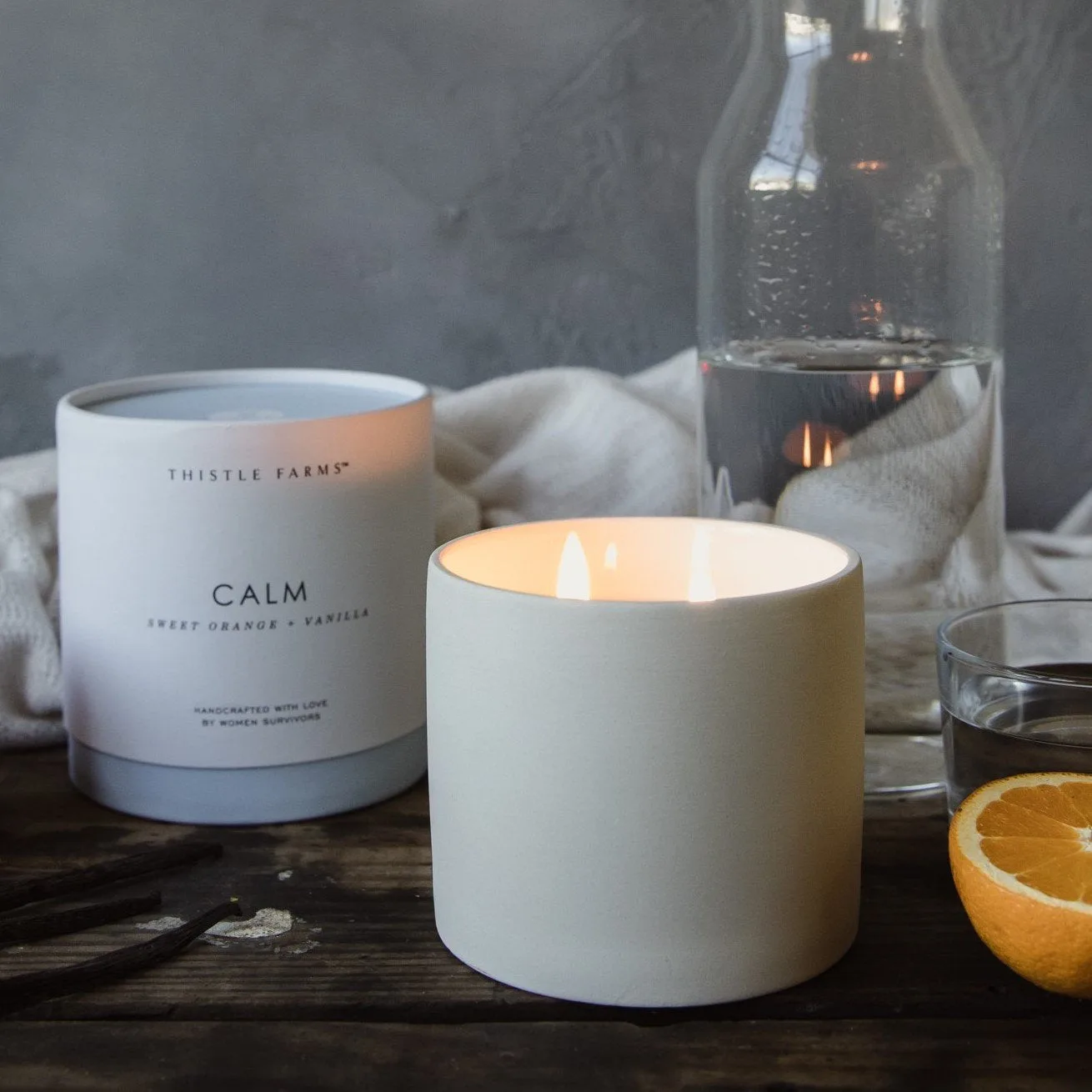 Thistle Farms Calm candle jar with sweet orange vanilla patchouli label detail