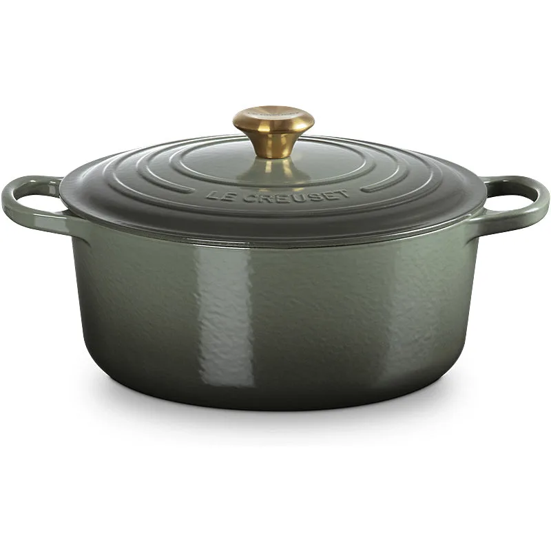 Le Creuset round Dutch oven in Thyme Green being used on a stovetop