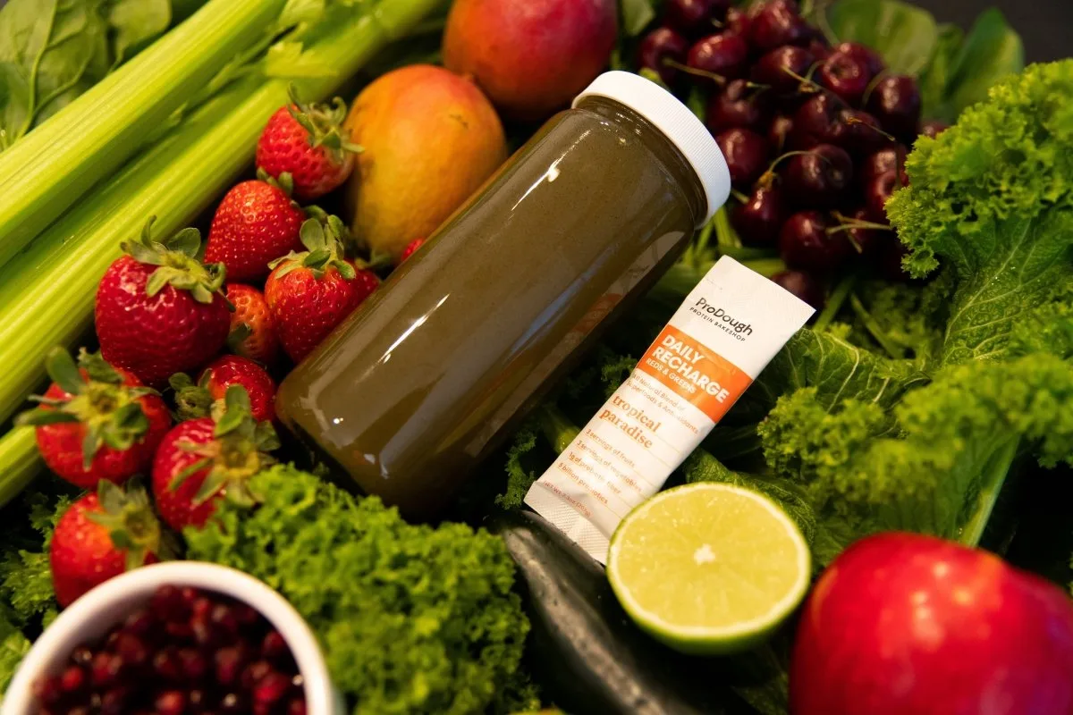 Prodough Daily Recharge Reds and Greens supplement pack showing probiotic and digestive enzyme claims on the label