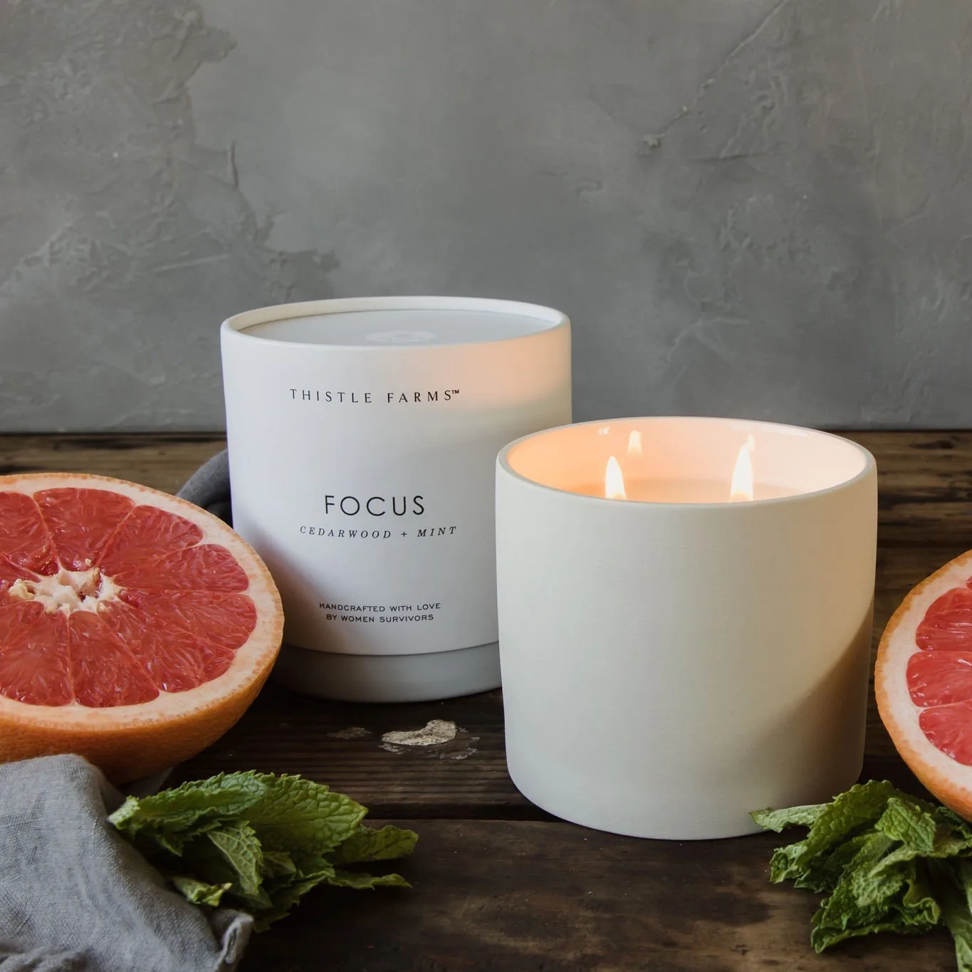 Thistle Farms Focus candle jar with mint citrus floral label detail