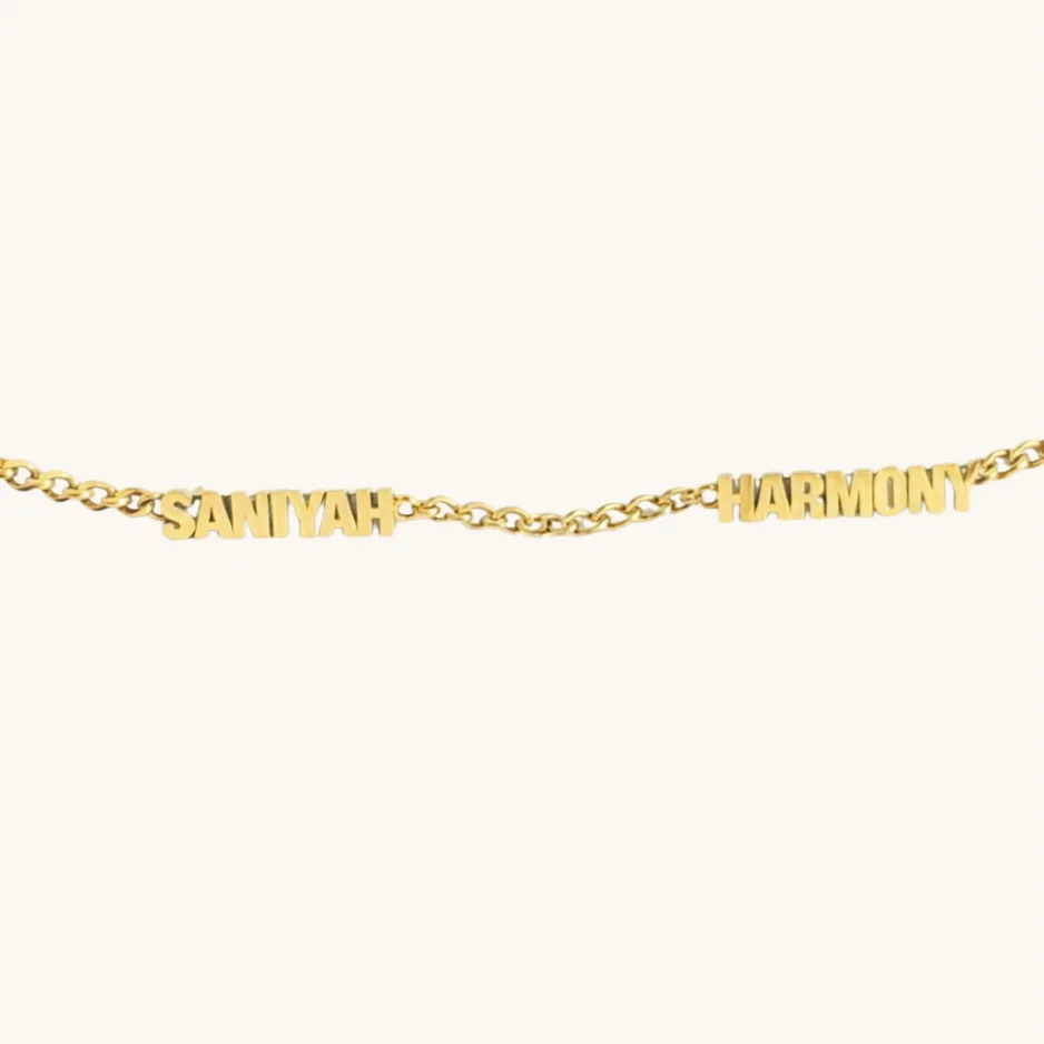model wearing layered personalized necklaces of different chain lengths