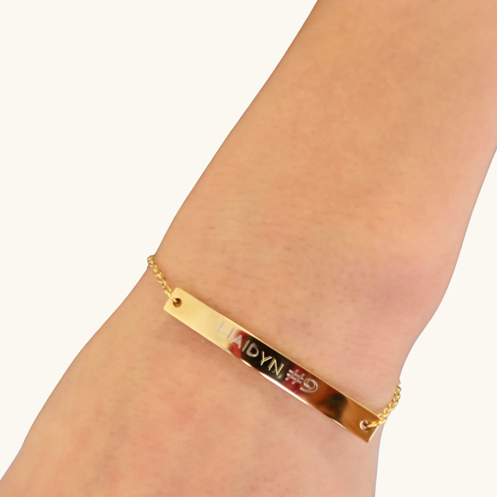 Layered personalized name necklaces with birthstone accent styled together