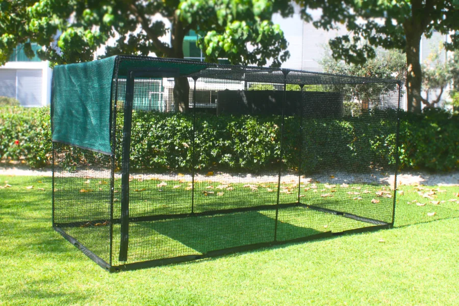 LuxeyPets Cat Enclosure XL set up in a backyard with two cats exploring inside the netting